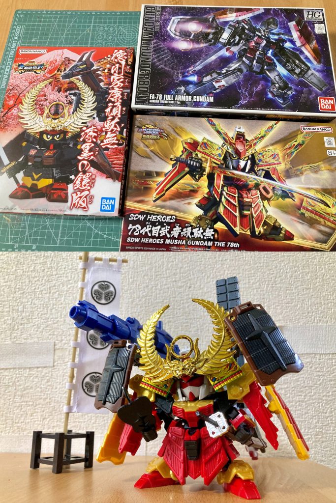 関ヶ原合戦、大坂の陣で大量の火砲を用いた徳川家康の大筒イメージと、サンダーボルト版フルアーマー・ガンダムの重武装・高火力という特徴を重ね合わせた配役設定としています。またSD戦国伝・武神降臨編「徳川家康頑駄無」が、元キットがファーストガンダム大将軍という事で両肩部に大袖のような大型シールドを2枚装備している印象が強くありますが、こちらもサンボル版4枚盾の特徴的な外観とイメージの重なる所を感じて同様に再現しました。ほかフルアーマー・ガンダムの大型ビーム砲に見立てた右肩部の大筒はSD武者烈伝「剛熱機械師駄舞留精太」より、左肩部のミサイルランチャーはお馴染み「ボールデンアームアームズ」のBランナーのパーツ、2連ビームライフル状の種子島銃はLGBB武者頑駄無のものを改修して取り入れました。歯朶前立兜パーツは「徳川家康頑駄無 漆黒の鎧版」の方から使用したので金メッキVer.の豪華版仕様です。（大太刀の鍔も同様。）背部大型バックパックはHG1/144そのままなのでやや過大ですが、大筒キャノンとのサイズ感のバランスやスラスター部分の先端が接地して自立が安定する事、種子島銃をマウントした際の長さがピッタリな事など色々ちょうど良かったので、若干の接続調整のみ施して大きくは加工せずあえてそのままのサイズで採用しました。