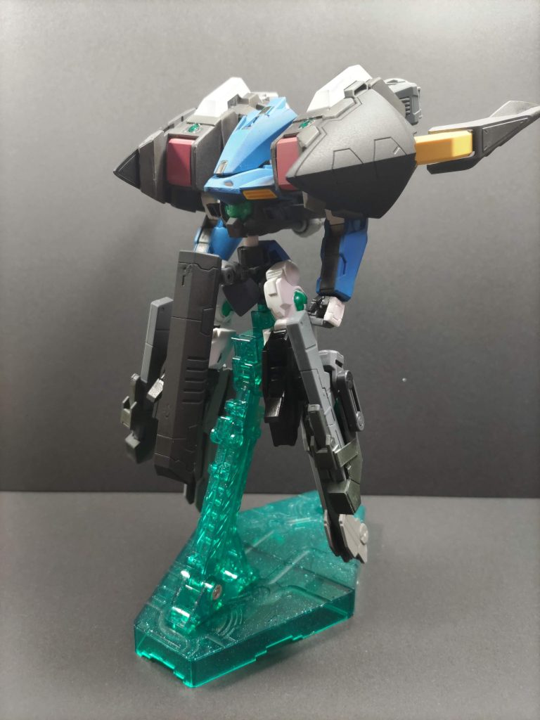 設定刹那がエルス母星に旅立った後、新機体のために追加の太陽炉が必要になった。しかしエルスや連合の調査団など複数の勢力が入り乱れるようになった木星での製造は困難を極めるとされる。本機は製造施設の防衛、周辺警戒を目的に木星に到着するまでの間に建造されたMSである。