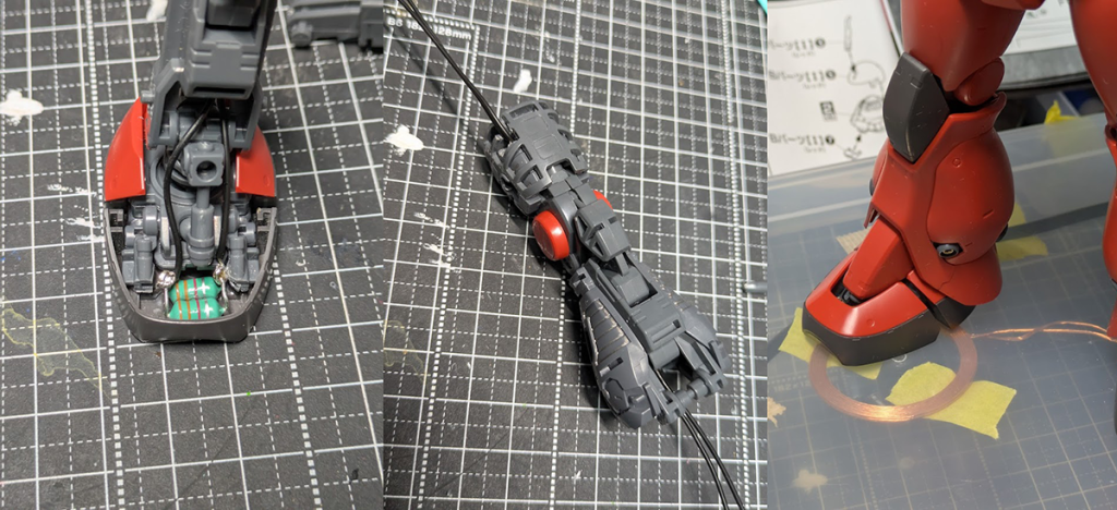 こんな感じで、つま先にインダクタを仕込んで送電コイルを踏んづけると光る仕組み。いい感じにドリルで穴を開けて、足先から体の中までリード線を通して首の後ろから頭に繋いでます。