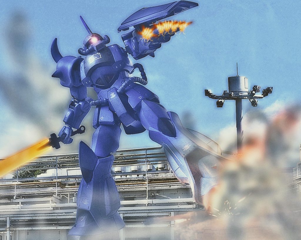 「なんて数がいるんだっ!?」リンドヴルム隊隊長ビリー・ウォン・ダイク大尉は足元の61式戦車を力尽くで踏み潰すと、左腕部のフィンガー・マシンガンで自身を狙っていた他の戦車を狙い撃つ。旧来の戦車と言えど、数が揃うと侮れなくなる。フィンガー・マシンガンは高火力とまでは言わないが、戦車の装甲なら楽に撃ち抜ける。群れをなしていた61式戦車は被弾すると、グフに近いものから順に炎を上げていった。「…ビリー、引き際を間違えるなよ…」ビリーは自分に対して声を掛けた。敵基地の戦力は想像以上にあり、今の所は全機戦闘継続が可能だが長期戦になれば確実に隊は全滅する。ここまでビリーは2機のMSと多数戦車を撃破してきたが、自分達の進路を遮ろうと基地から敵が湧いて出る。「リンドヴルムリーダーより各機へ!私を中心に集まれ!全機集り次第一点突破により撤退を開始!ドダイとの合流地点ポイントΒまで移動する!」