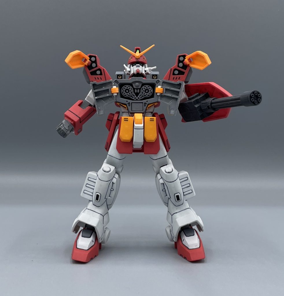 全弾発射!! ヘビーアームズは、”歩く弾薬庫”と言えるほどの大量の武装をその身に宿しています。取説によれば、ヘビーアームズの火力は戦艦3隻分とも5隻分とも言えるほど強大だそうです。 敵機を前にしたヘビーアームズは、弾薬を出し惜しみすることなく、容赦ない弾幕をばら撒きます。すると訪れるのはカタカタカタカタ・・・  必然、弾切れになります。ご丁寧にガトリングを空回りさせる演出をはさむことで、「弾切れだァ!やっちまえ!」と敵機の接近を許しますが・・・・・・・・・・ ズバァッ!!!!