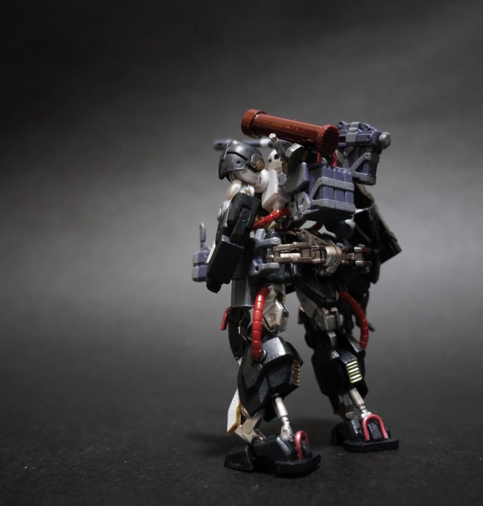 7.    ローカルゲリラ組織につき、潤沢にMSを保有しているわけではなく、防衛戦闘のほかに物資や大型車両の牽引や、装備の換装をしやすくする用途で機体各所に赤いフック(ロールバー)がしつらえられていることが大きな外観上の特徴である。