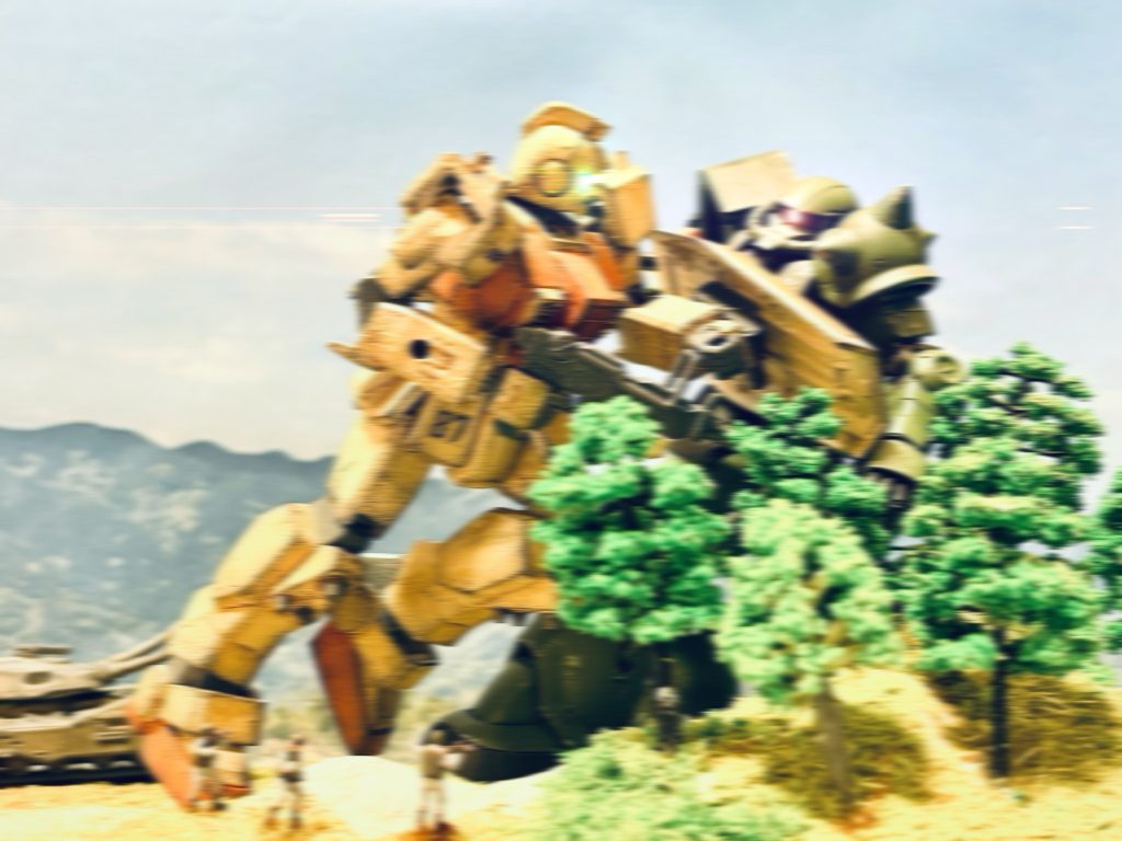 すさまじい地響きと共に、もう一体の巨人が歩兵隊の視界に飛び込んできた。イギー少尉の駆るジムが、ザクに体当たりをかます。「イギー少尉!」鋼の巨人同士がぶつかり合う、鈍く、重い音が響く。