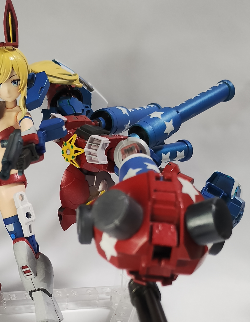 ゴッドのときのように複数形態は用意しませんでしたが、支援武装モジュールの「ニトロユニット」をでっちあげました。ボディに大型の両腕2本、ブースターがモリモリっとなった武装モジュールです。石破天驚拳などのリーチと火力を両立する攻撃に対抗するために用意した、ファイターの思考や動きで操作できる超大型ビット……という設定。 マンガ「超級！起動武闘伝Gガンダム」に登場するマックスターの後継機、ガンダムマックスリボルバーを意識したデザインにしています。拳についた突起物、胸の★、背面から延びるマフラーめいたパイプ…全体的に、星条旗をイメージした星マークで塗り分けを行いました。 画像のように、ファイターの射撃シチュエーションでは、ニトロユニットの拳から大型マシンキャノンが突き出して火力支援を行う仕組みです。