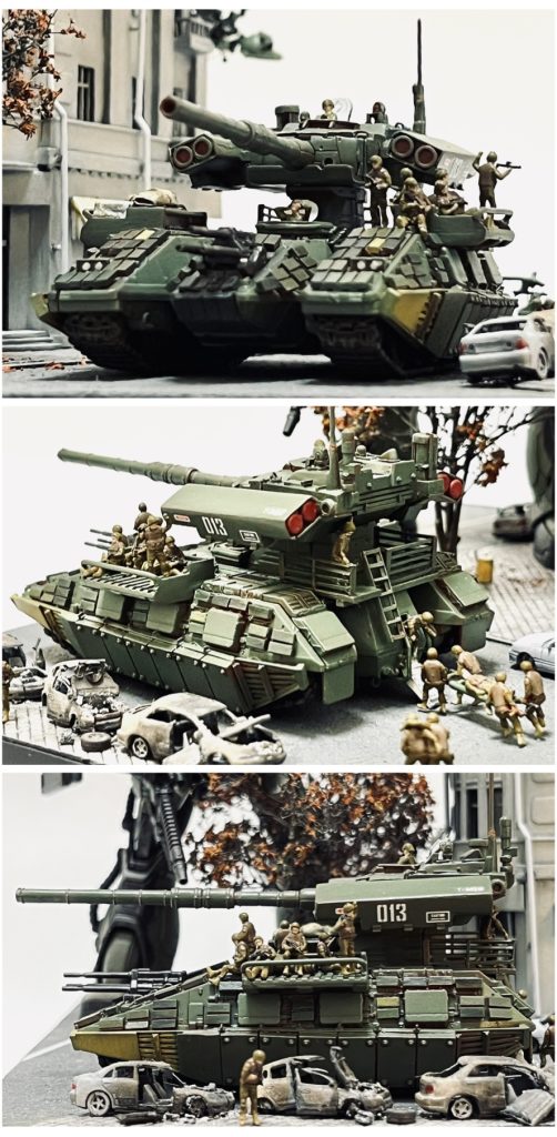 オデッサ防衛戦が初陣となった改良型マゼラアタック…。開戦当初、砲塔が分離し飛び回る姿を見て驚愕した連邦軍ではあったが、慣れてしまうとどうと言う事もなく…(笑) 飛び回る前に砲塔を撃破、もしくは飛行中としても飛行速度はドップと比べるもなく対空火器にて容易に撃ち落とす事が可能であった。東ヨーロッパ戦線においては多数のマゼラトップが撃墜される事となり、その様は「ルーマニアの七面鳥撃ち」と連邦から揶揄されるに至った。連邦の本格的なMS導入による大規模反攻作戦を前に運用の見直しがなされた。トップの両翼を対MS大型ミサイルに換装。反応装甲タイルによる防御力強化が実施された。また車両不足を補う為、ベースの両サイドに荷台を設置し物資や兵員輸送も可能とした。地球侵攻当初の航空兵力代替兵器としての役割を終え、こうして誕生したのが「飛ぶ事を辞めたマゼラアタック」