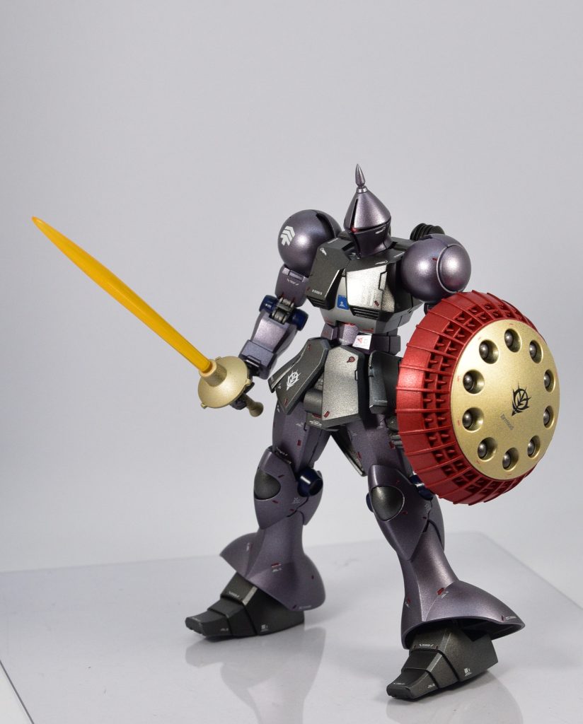 劇中のブラック/パープルをベースに、差し色は赤です。工作はシャープ化、手首合わせ目消し、モノアイ立体化。デカールワークを経て半光沢トップコートでフィニッシュです。