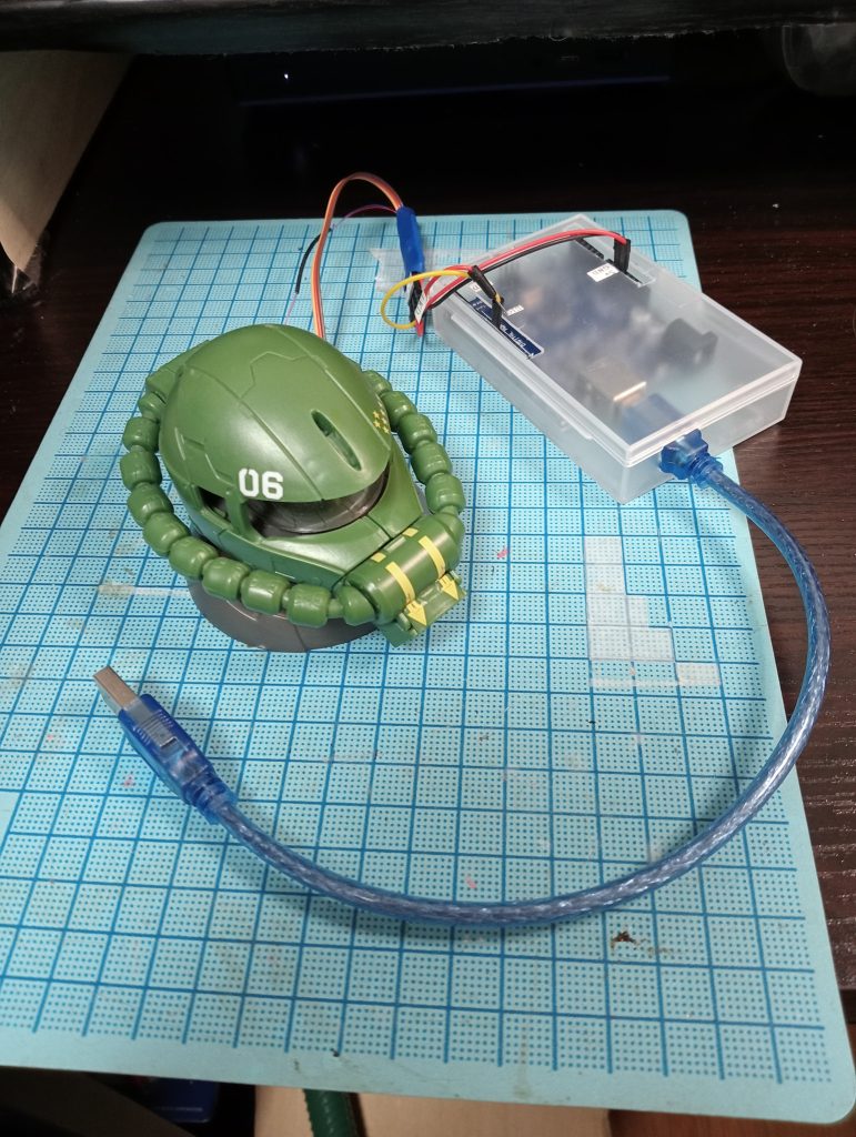 さて、今回、まあ皆さん思いつくであろう「サーボとLED繋いでマイコンで制御する」を頑張りました。まあ、元々、目は手動で動かせますし、LED付ければ目が光りますし。ただ!!これを小学生の電気の理解と、中学生時代にトランジスタラジオを技術の授業で作ったときに「芋天ぷら職人」の称号を技術の先生から賜った私にできるのか!?が最大の問題だったのですが、案外やればできるもんですね・・・。ちなみにマイコンはArduino UNOというものを使いました。おかげではんだごてほとんど使わずに、しかも電子回路なんて考えなくてもできました。あと、中学生のころ、夢中で読んでいた「プラレス3四郎」が忘れられず、パソコンからのコマンド入力で・モノアイ点灯/消灯スイッチで切り替わる感じではなく、ブオンって感じに点灯し、スーって感じに消灯・モノアイ移動左右に最大30度移動します。実は左右90度に移動できるのですが、モノアイの前を覆っている透明プラスチックに干渉して、ガチャガチャ言うので干渉しない位置で止めています。・モノアイの明るさ調節0~100の間で明るさを変更できます。・点滅モノアイを点滅させます・デモ動作毎回必死でコマンド打つのが面倒だったので、モードをデモモードにすると、決められたの動作を連続して実行します。(モノアイの明るさを変更しながら、モノアイを移動するなど)なんて機能を組み込んでいます。反省点としては・塗装とかしていない素材の味を大事にする(塗装が泣きたくなるほど下手)人なので、放置・電源投入時誤動作するときがある。迷走電流?とかなにかのせいらしいのですが、よくわからないと頻度がかなり低いので放置・デモモードでそんなに多くコマンドを設定できないメモリが足りないらしいのですが、マイコン詳しくないので放置てな感じです。(反省してない)頑張ればクビも回せそうな気がするのですが、そのためには電流が足りないっぽいので、またの機会に挑戦するかもしれません・・・。・・・その前に罪プラ崩さないと、怒られそうですが・・・。そもそもガンプラというより電子工作な気も・・・。