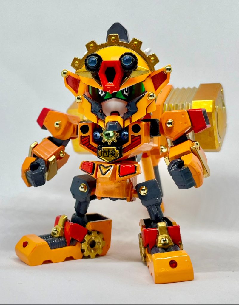 金流出真亜具(ゴルディマーグ)天界の神器である金流出御小槌(ゴルディオンハンマー)を武者ガオガイガーが扱える様に、武者駄舞留精太やからくり一門が作製した鉄機武者という設定です。