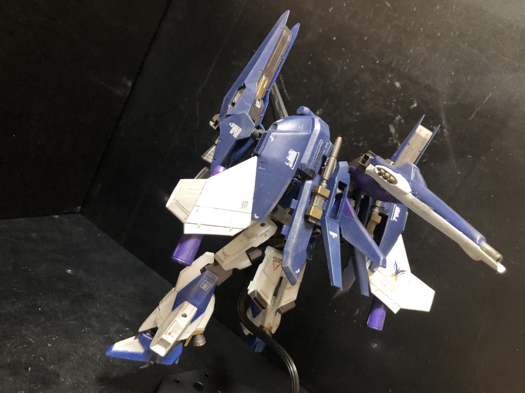 リ•ガズィ ライトニングカスタムの制作にあたり、リ•ガズィとライトニングガンダムを主に使用したが、相当の余剰パーツが発生した。特にBWSが丸々余ってしまい、機体特徴が大きいパーツである事から他での流用に向かず、そもそも制作にあたり提供されたキットであるため、個人的に横領してしまうのは非常に気まずいものがあった。その為、制作依頼とは別に考案したのがB装備となる。