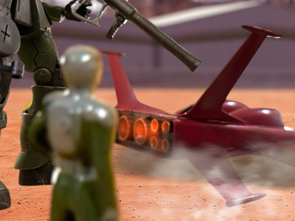 「攻撃には接収したドダイを使おう。」格納庫から引き出されたドダイが、暖機運転を始めている。「なるほど、空からの奇襲ですな。それなら足音を聞き分けられる心配もない。」 さすがに、オスカーは作戦の理解が早い。連邦軍のMS隊に随伴している指揮車輛には、敵機を探知できるソナーが搭載されているらしい。地中に打ち込んだソナーから、MSの足音を探知するというが、これがなかなかの精度らしく、普通に接近するとすぐに狙撃される。しかし、空中からの奇襲ならば、捕まらないだろう。「とにかく第一目標は“ガンダム”だ。連邦の脅威の象徴たる“ガンダム”を討ち取れば、味方の士気も大いに上がろう。」「逃げる兵士に士気を求めますか。」マイロも、軽口を叩く余裕が出てきた。死線をくぐり抜けて、肝が据わってきたのかもしれない。「大将首はお譲りしますよ、大尉。」すかさずオスカーも続ける。「誰だっていい。とにかく我々が討つのだ、