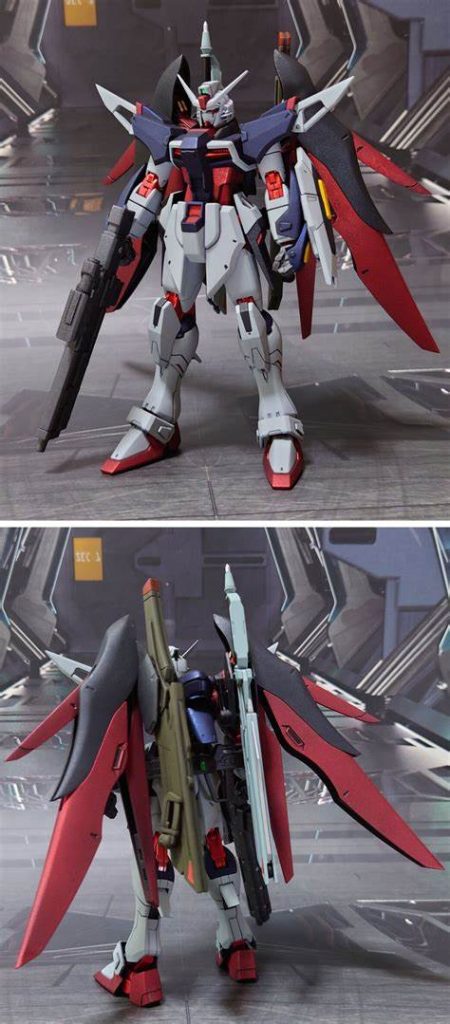 デスティニーガンダムSPEC2(最大稼働)、前後ろ。工作は、ゲート痕再処理、エッジ尖らせ、パーティングライン・段ズレ・ヒケの対処、面出し、自分に可能な限りの合わせ目消し、市販パーツ貼り付け・埋め込みによるディティールアップを実施。手首はビルドハンズ(角)Mサイズと武器持ち手の手甲を加工し、握り手を追加。腰フロントアーマーを削り込み、気持ち程度の小型化。色味に関しては、手持ちに良い具合の青と赤が無かったので安易にメタリックに振った結果、暗くなりすぎたと感じました。しかし、組み上げて実物を見ると案外悪くない感じになったと思います。