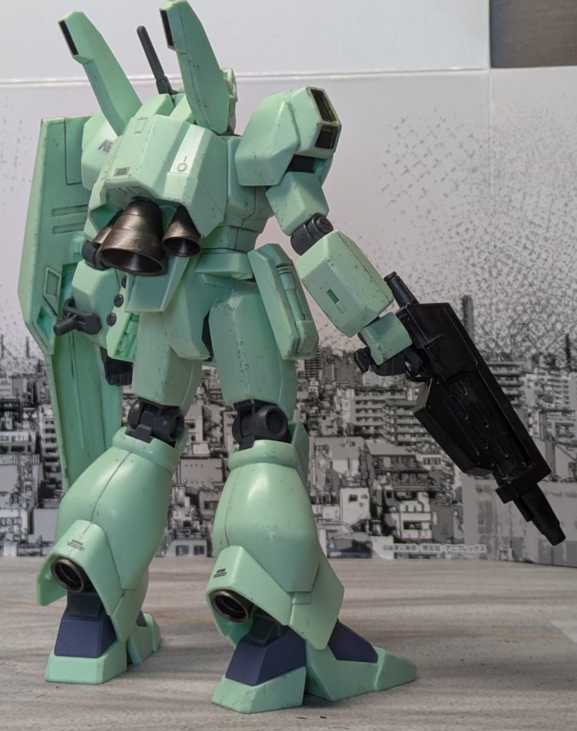 アナハイム内の開発競争と軍縮という壁に当たりJ型開発は凍結されたが、高機動試験機という名目で非公式に開発は続けられ、更にJ型の性能に興味を持ったサナリィがアナハイムのJ型開発陣を密かに支援し、国連軍上層部とパイプがあるサナリィの口添えで運用試験機という扱いで量産試作3号機がイズマ事件に出動していたロンド・ベル隊所属第10独立艦隊旗艦[ペガサス]に配備された。ペガサス配備後は同艦専属MSパイロットであるドゥー・ブル大尉がパイロットとなって運用された。元々ドゥーの機体はRGM-89Sスタークジェガンであったが、任務中の損傷により一時的に使用不能となっていた。更に艦隊自体が独立部隊という事からMS配備数が元から少ない中で艦載機が減るという緊急事態という事で緊急補充機として配備されたという経緯もあった。