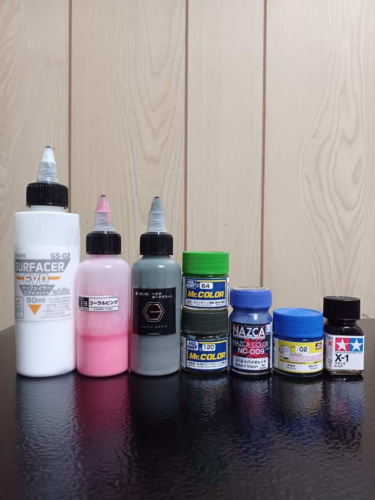 ※使用した塗料です~。白サフ→中央グリーン系を調色→右ブルーを調色。モノアイはピンクを筆塗り。枠は白サフとルマングリーンを調色です‼️ABSにラッカー系は割れやすいのですが、サーフェイサーを塗布する際に砂吹き気味にして薄く重ねます。感覚的には吹いて数秒で触れるくらい。ラッカーの層が出来上がれば、普通に塗装しても大丈夫だと思います。割れやすいのは事実なので、自己責任で塗装してます(zaku-kao4)