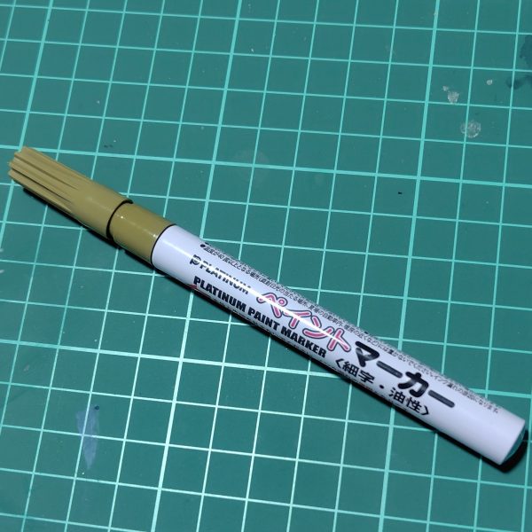 まずプラウドディフェンダーが完成しました。機首のグレー部は本来シールを貼る場所ですが、シールはそのうち剥がれることが多いので塗装にしました。塗装は刀の鍔以外は全てガンダムマーカーです。イエローゴールドはエアブラシシステムで。グレーとブルーはペンで直接塗ったらムラムラだったので、筆塗りに変更しました。刀――フツノミタマは白の１パーツ成形だったので塗り分け。鍔の部分は前にDAISOで買っていたペイントマーカーを筆塗りで。110円といえどもさすがペンテル、いい発色です。ただしもともと塗装用ではないので、インクを出してもすぐ乾いてしまいます。（4枚目）