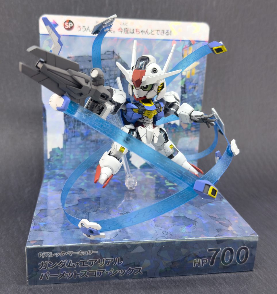 「私達でミオリネさん助けるよ！」 そしていつものカードダス台座も製作今回は9話のシャディク戦、初パーメットスコア覚醒時をイメージした背景で作成を行いました。右肩のダメージ装甲とかも時間があれば作りたかったな…