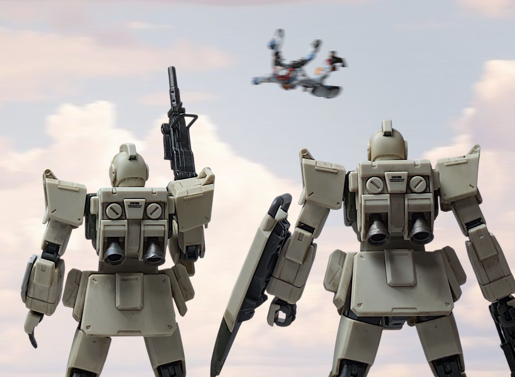 UC.0095.12月2日。チベットラサ北部警備区域。スミス[ なんだあれは?]シンプソン[警備司令部、こちら第2パトロール班。未確認MSが上空よりこちらに接近中]スミス[マズイ!!突っ込んでくるぞ!!]マチュ[受け止めてぇぇぇぇ!!!!!!!!!]そして応援のため現場にグフカスタムと共に到着したハモンドと警備部隊が見たのは捕獲されたエイリアンのように両肩をジムに支えられていたジークアクスだった。ハモンド[これがシャリア・ブルが言っていた