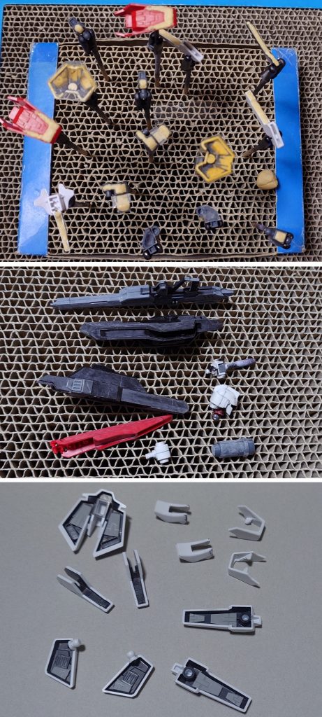 肉抜き穴埋め、合わせ目消し、ディティールアップ工作中の様子。肉抜き穴埋めは、首関節裏、腰フロントアーマー中央裏、膝パッド裏、脛外側スラスター裏、足首関節、足の爪先裏、フライングアーマー接続パーツに実施。合わせ目消しは頭部、肩関節(上腕側)、フライングアーマー、ビームライフル、シールドに実施。フライングアーマーを前腕に接続してビームトンファー的に使うギミックは排除。ビームライフルのグリップ・カバー可動及びジョイント用ダボは削り落とし、シールドの手持ちグリップも排除。ビームライフルの前腕へのマウントも出来なくなりますが、不要だと判断しました。