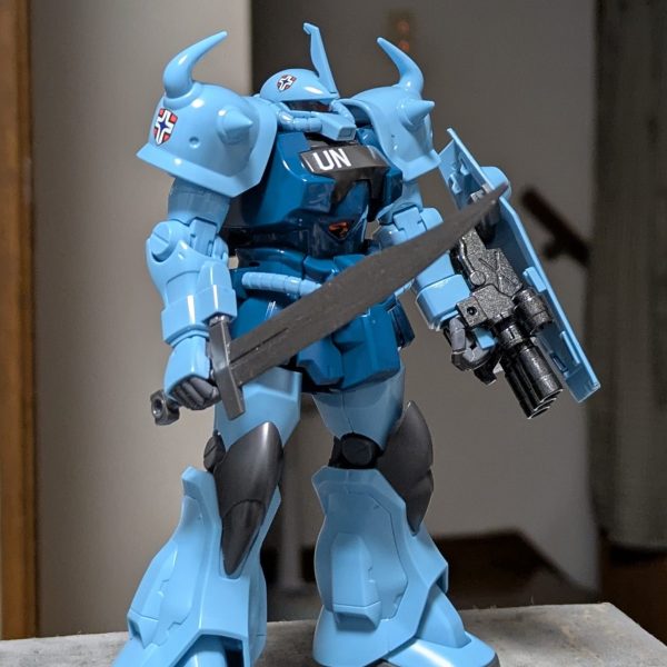 HGUC MS-07B-3 グフカスタム製作中!今日は武器類の組み立て&デカール貼り。元ランバ・ラル隊隊員で北米ジオン軍エースだったヘクター・ハモンドがUC.0095のラサで国連に雇われたPMCとして搭乗している機体なのでランバ・ラル隊の隊章とUNマークが同居している不思議な状態。因みに機体番号の23はハモンドが北米時代に所属していた第23独立コマンドに由来。（1枚目）
