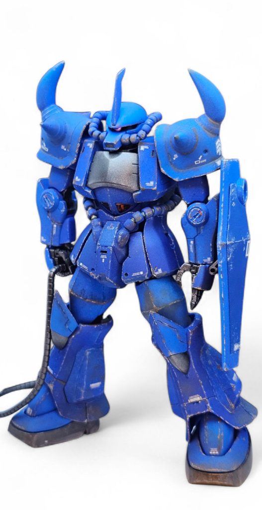 プロポーションは定番のグフカスからのショルダーと靴の移植をしてます。頭部カットによるモノアイスリットの形状変更もしてます。モノアイはLEDを入れてます。胸部はプラ板でボリューム増し、腰をS字立ちしやすいように形状変更。動力パイプをカスタムパーツに変更。バックパックへシイタケディテール追加。脚部は股関節部分で2mm延長。ショルダースパイク前後はカスタムパーツへ変更。メインスパイクはグフの物をパテで延長してます。手はカスタムパーツへ変更してます。指が1本1本動かせます。その他膝部分とアンテナもパテで形状変更しています。後は多少のスジボリとプラ板でディテールの追加をしています。