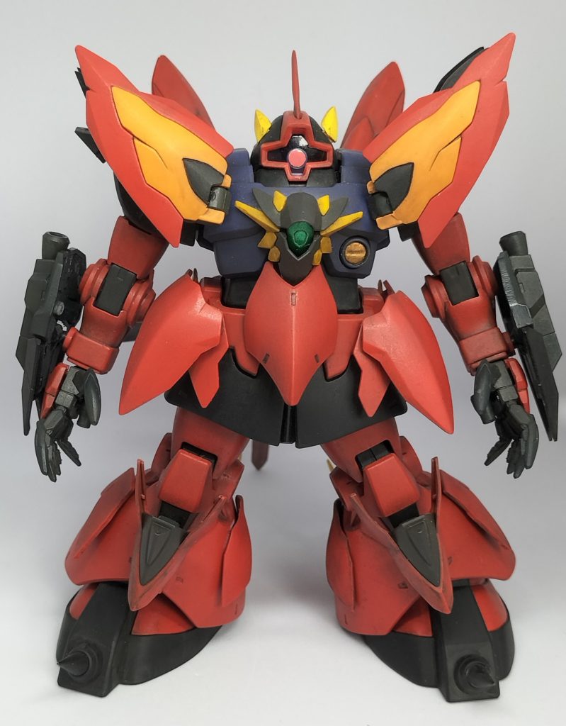 ヴェイガンが、EXA−DBから発見した『ドム』なるMSのデータを元に、自軍の高性能機であるギラーガとゼイドラのエッセンスを加えて開発した機体。ドムのたくましいシルエットや大地を疾走する様は、マーズレイで多くの人命が失われるヴェイガンにとって、健康体の象徴とも言えるものであり、多くの羨望を集めたという。本機には、イゼルカントが息子を亡くしたことを知った開発陣が、将来子どもたちがドムのように健やかであるようにとの願いを込めて開発に至ったという背景がある。子どもたちには良い服を着せたい、美味いものを食べさせたいといった想いから、いつしかヴェイガンの傑作機たるギラーガやゼイドラのパーツが組み込まれていった。いつの世も、子を想う親の心は切なく胸を打つ……。やがて完成した機体には『ドムドラーガ』の名が与えられ、ヴェイガンの子どもたちを守るために戦場へと飛び立つのであった。