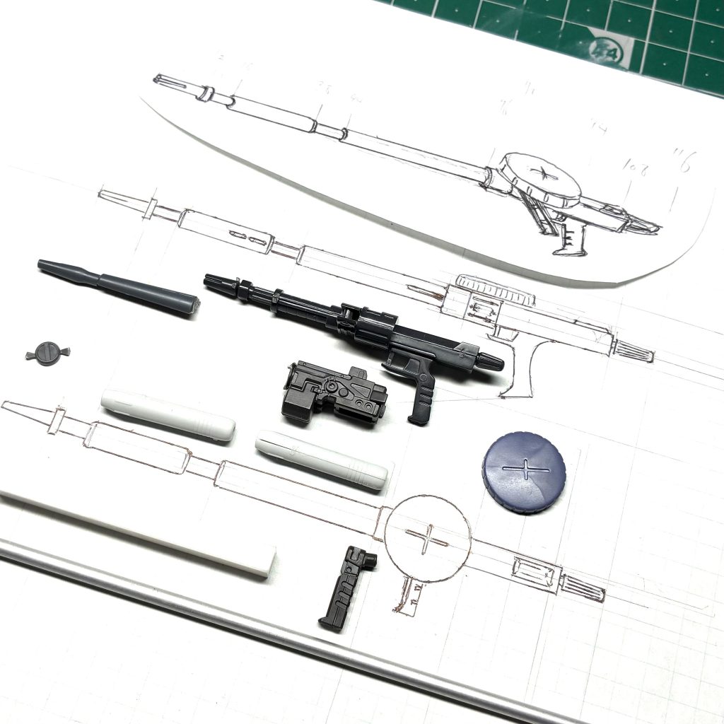 イラストを見る限りでは、旧ザクのザクマシンガンに似た形状をしていたため、ベースはそれを使用しています。その他は、ジャンクパーツを漁りながら似たようなパーツを並べて構想を練りました。ドラムマガジンはハイザックのザクマシンガンの物を使用しています。