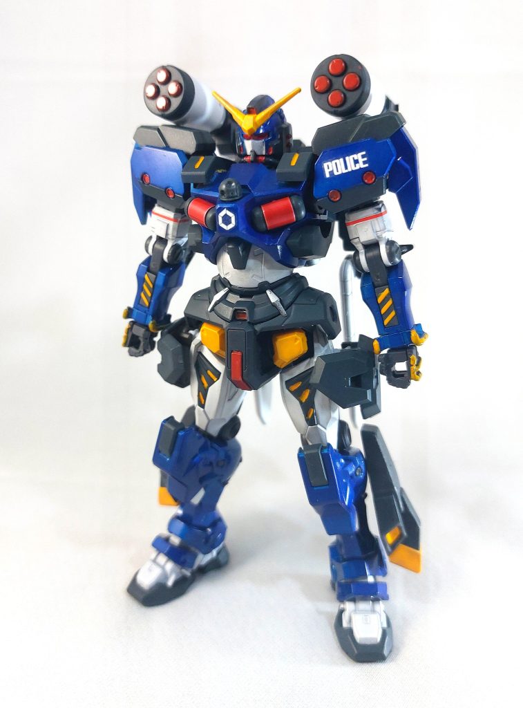 戦後、サイド6軍警察は民間向けに払い下げられた「ザク」を主力に配備していたが、度重なるMS犯罪や違法バトル参加者を強固に取り締まるためザクよりもやや高性能な連邦軍の「軽キャノン」をベースに推進ユニットと高性能センサーを施した機体。