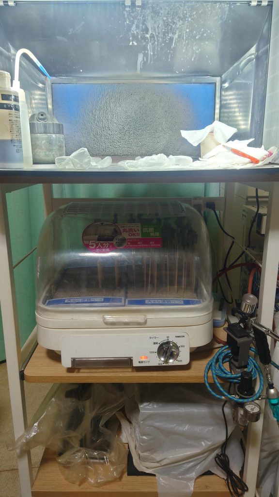 塗装していきます。これだけで作業に必要なほぼ全てが集中しています。使っているのは・山善 電子レンジラック ～専用の机がないので用意した塗装台。キャスター付きで不要な時は移動できます。コンセント付きなので便利・Urlife 塗装ブース DFPB01B ～塗装必需品その1。折り畳み可能、LEDライト付き、吸引力変更可能と使いやすい。フィルターが汚れて吸引力が落ちたら交換必要だけど簡単に変えられます。フル稼働中の音が掃除機とかドライヤーを耳直付けで聞いてるかのように大きいのが欠点・タミヤ スプレーワーク パワーコンプレッサー+防振マット ～塗装必需品その2。元々水性塗料を吹こうと思い調べたらそこそこの圧力が必要との情報が出てきたので、大出力のコイツを選択