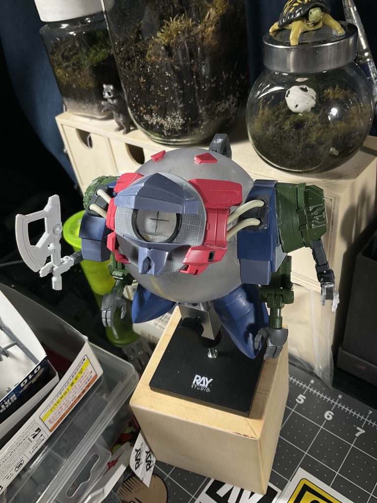 heres a look at the ball before I started painting. You can see all the different parts I used here. Zeong, Aegis Gundam, Chu Chus Demi Trainer, those are the most notable parts.