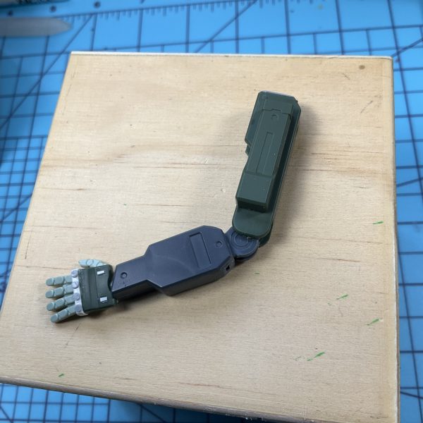 I had an idea early on that one arm should be an oversized arm designed to operate heavy equipment. I do quick and rough sketches like this all the time, they don't have to be very exact, just a general idea of how it will look. That way I can still make spontaneous decisions when kitbashing, while still following a loose guide. The frame work for the arm is build out of parts mostly from the same kit, the Grimoire Red Beret, it looks really skinny but more plaplate and other parts get added on to bulk it out. The shoulder comes from Chu-Chu's Demi Trainer, a thigh armor, which has been reshaped to what you see here. After that smaller details and scribes were added on.（2枚目）