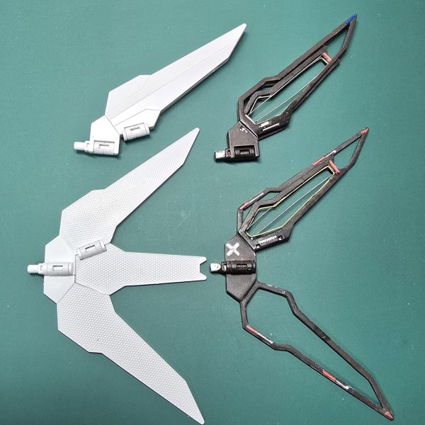 あとは最終のトップコート・微調整を残すのみとなりました。制作中最終報告は、武装等の元キットとの比較です。バルバトス用滑空砲を削った盛ったしてキャノン砲に改造ディフェンスプレートはオリジナルの三角形から四角にほぼプラ材でスクラッチリフレクターはフレーム状にしたまではよかったのですが幾度もポキポキ折れて🤣強度を考えて展開状態で6枚羽を４枚羽に変更、フレーム風加工の厳しさに痛感😆いい勉強になりました😂近々天気のいい日にトップコート吹いて完成品アップします😆（4枚目）