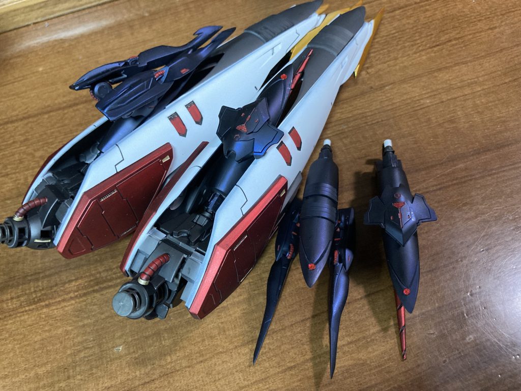 かなりいい閃きだったなと思ったのはこちらの新型プルーマになります元々はハシュマルの内羽みたいなものが付いていまして、腕動かすのに当たるし、邪魔っぽいかなぁと、とりあえず切ってみてしばらく眺めてたらプルーマぽい、か？となり、元々のプルーマキットがハシュマルについてきて二つあったこともありじゃあ内羽ついてたところから生やしてというか、MAにはプルーマの量産機構があるっていうから、長年謎だったどっから出てくる？をここからにしよう！と、ついでにプルーマにも腕つき、ドリル付きの2パターンに増やして小型化アーム付きはアニメで出た通り組みついたりドリル付きはプルーマそのものが弾丸のように飛んでくる特攻隊みたいな役割だったら面白いかなぁと、宇宙に出てもただ飛んでくだけでも厄介なのはダインスレイブ見てれば使えるかなとw各羽に4機分のジョイントを接着してプルーマをくっつけることもできます