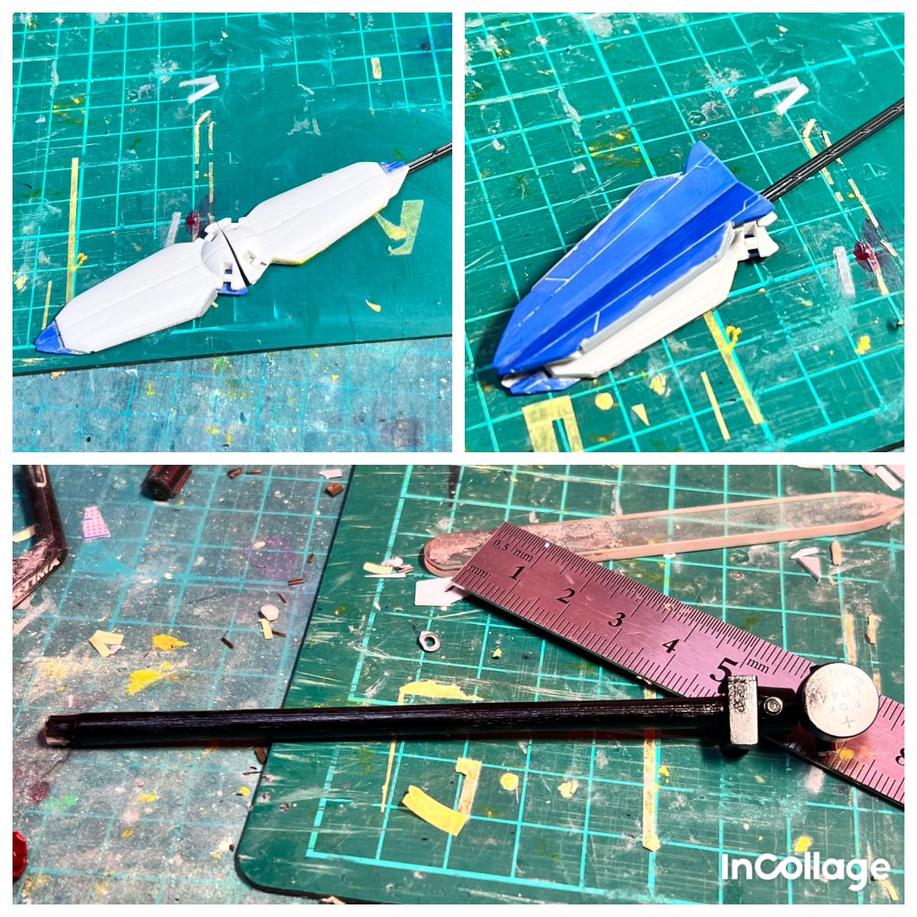 オキツノカガミ… （設定ではハイペリオンの技術が使われたビームバリアを展開出来る天ミナの追加兵装）をモドキですが自作しました。盾パーツはXディバイダーのハモニカ砲の裏にストフリのドラグーンを貼り付けて形作っていきました。写真下の黒棒は軽く火で炙った後に炭を落とした割り箸です。その箸の先端にボタン電池を接着して、ネオジム磁石を仕込んだ盾が棒の電池部分にくっつき合体するように作りました。