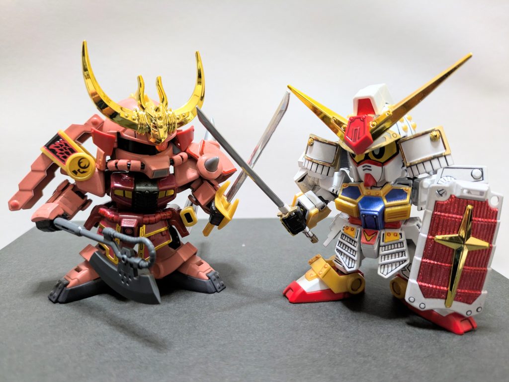 〝見せてもらおうか、地上最強の武者の実力とやらを！！！〟武者シャアザクは「伝説の大将軍編」の魔殺駆として脚光が当たるまでかなり不当な扱いを受けてきました。主要な悪役となるはずの「武者七人衆編」では緑ザクにお鉢を奪われ、シャアザクなのに赤くない影忍者射殺駆という超脇役に追いやられました。アムロとシャア同様、ちゃんとした宿敵として白帝頑駄無と闘わせたい…その想いがここに実りました。