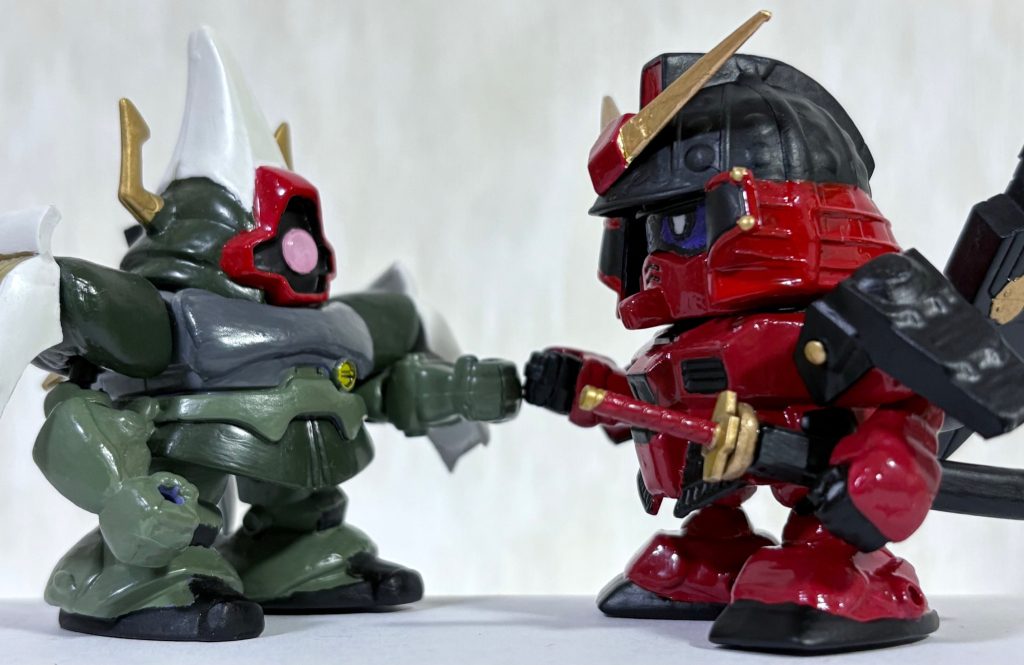 今年初めに作った武者怒武とツーショット。彼の名は射吏亜撫瑠（シャリア・ブル）と言い、覇螺烈流世界における農丸の戦友である。他にも雷電・飛燕・月光からなる三面剣の武者が仲間にいる。