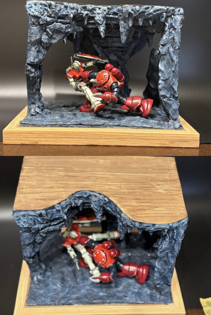 ⑤空間の活用⑵正面からの写真(写真上)ではベースに対してGMシャアズゴは平行に配置されているように見えますが、実は上から見ると右手前から左奥へ配置されているのです。(写真下)この配置のねらいは狭いベースでも窮屈さを感じさせないこと、そして奥行きを出すことです。この奥にまだ洞窟は続いている感を演出しています。ちなみに天板はプラ板木目塗装です。木に見えるかな😅