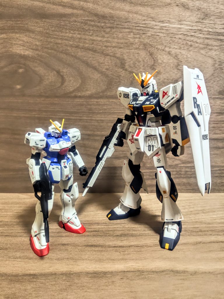 さて、凄い画像が出てきましたね。これが大型化された時代のνガンダムと、そのかなり後に来るモビルスーツの小型化時代のヴィクトリーの比較です。1/144スケールと1/100スケールのガンプラじゃないですよ(笑)。これは何と言うか、凄いよね。おまけに、ヴィクトリーは可変モビルスーツでさらに別れて変形するってあなた、「凄すぎるやろ(笑)」そして並べたときに幸せになれるルックスの良さ。ポンコツ年寄りの手抜きフィニッシュにしては、まずまずのクオリティに見えます。エントリーグレードの凄さと、ハイグレードの良さ、どちらも量販店で1500円以下で買えます。これは嬉しい、安い方が大きいのは謎だけど。。