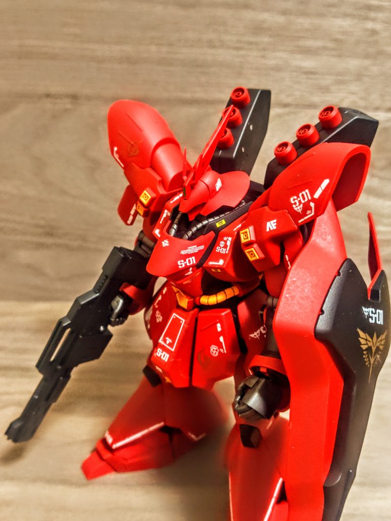 成型色の赤は、実は2色ありました。元々このキットはそれらを使って立体的に赤の色の層を見せてくれるんですよね。そして黄色はややオレンジがかった感じで、これもいいアクセントになっています。あとは黒、今回はこの黒だけをメタリックブラックでランナー塗装しました。艶消し吹いたら単なる黒に(笑)。そしてABSの関節や指がメタリックグレーの成型色ですね。ここ、充分綺麗なんですよ。メタリックグレーの雰囲気がいい感じで、ABSらしく固くてカチッとしていますし、無茶苦茶良い味出します。成型色による塗り分けが本当良くて、パチ組みで迫力あるサザビーを誰でも楽しめる、良いキットですよ。てか写真撮ってたとき気づきませんでしたが、右のファンネルラックの内側に静電気で何かごみがくっついてますね(笑)。そんなとこにバリあったかなぁーって、小さいビニールのかけらみたいなの、今取りました(笑)。