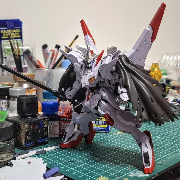 鉄血の映画でマルコシアスがとても好きになったので昔作ってバラバラの状態の機体をなんとか集めて形にしました。ですが、頭が別のガンダムに使われていたので別の機体のを移植しました。五枚目の画像が今では一枚目の画像に仕上がりました。昔掘ったスジボリを埋め直したり、合わせ目を消したり、エッジを出したり、さらに首と胴の延長をしたりしていくなか，マント有りの無しの状態でどちらにしようかとても悩んでいますね。&nbsp;（4枚目）