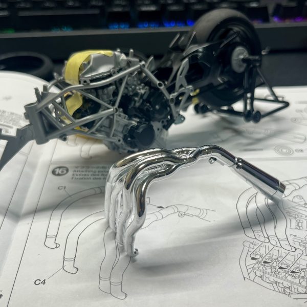 皆さま、明けましておめでとうございます。今回制作中のフラッグはコンセプト段階で可変機構をオミットする方向で進めていたため、長距離移動用のサポートメカ的なものがあればいいなと考えていました。そこで目を付けたのは戦闘機モチーフのNinja H2R、そうバイクです。フラッグ自体戦闘機っぽい意匠が多いので、Ninjaは結構相性が良いのでは？と思い、制作を進めています。バイクのプラモ自体は実は初めてということもあり、まだ仮組みが終わった段階ですが、塗装の関係上接着がほぼできない＋全然ハマらないビス止め(何度もビスを紛失しかける)という苦行を新年早々味わうことになりました。私自身バイクの知識が皆無なので、構造、部品云々はさっぱり分かりません。ということで今回は実車の設定ガン無視で制作を進めていきます(かっこよければそれで良し)。改造としては基本的に見た目が大きく変わる改造…というよりフラッグに合わせて形状を調整&ビス固定をなるべく減らす改造がメインとなります(サイズ感はピッタリなので)。その他、武器を懸架できるようにするとかアクションベースで固定できるようにするとか色々検討中です。長文失礼しました。それでは今年もよろしくお願いします。（2枚目）