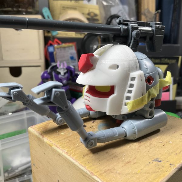 I took out a bunch of smaller kits with the intention of doing something fun before the end of the year (2025). Just before heading out for the day I suddenly realized that the B Gundam could be possible with a HG Ball and Gunpla Kun. Sometimes an idea is so silly that I have to see it through to the end.Hollowing out the interior parts of Gunpla Kun's head took a lot of time, if I had a router/dremmel it would have made things much easier lol. I had to adjust the head and make it more round shaped with pla plate, and getting the magnets to match was tricky too.I had the daiso hangar bay just sitting around and thought it might be fun to make it into debris, eventually settling on a angled backdrop style.（3枚目）