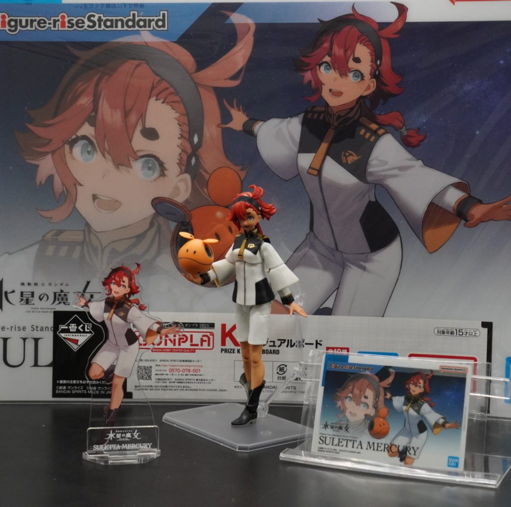 ガンプラ一番くじのビジュアルボード。パッケージアートコレクションのカード。パッケージアート、アクリルスタンド。一緒に撮りました。