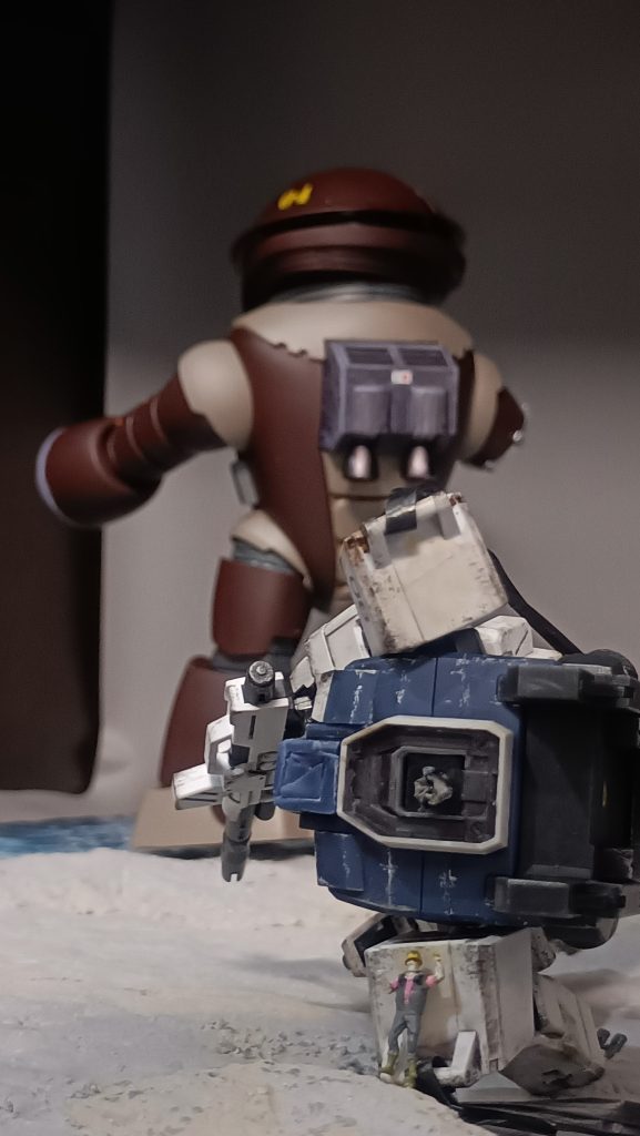 ホバートラックでミゲルが決死の陽動をかける中、カレンのもとへ駆け寄るエレドア。ピンクのシャツが目立つのでなんとかエレドアに見えるでしょうか。