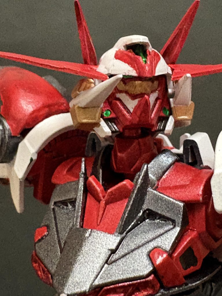 　顔面アップ。エリミネーターモードでは戦国アストレイのように口に装甲がついていますが、ダエモニウムモードではその金と白の境目が裂けて口に見えるように塗り分けたつもりです（だいぶ無理やり）。このアストレイ顔が良い。この状態だと顔の正面側のV字アンテナが後ろ顔では前に突き出た鬼のツノみたいに見える気がします。