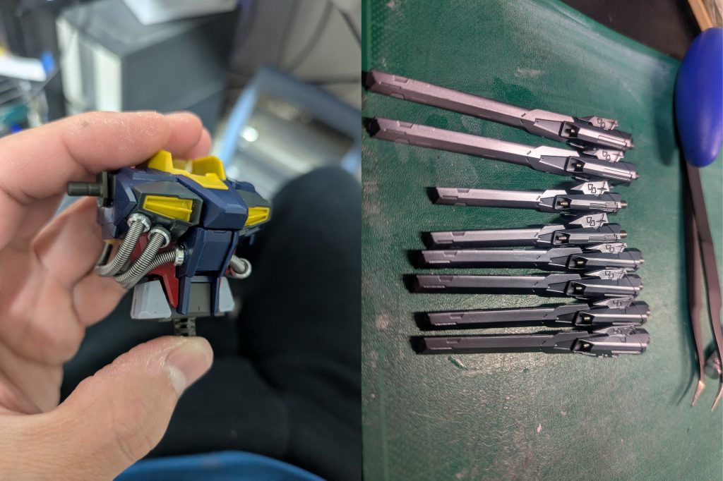 改修作業についてまず第一に、量子通信ケーブルのゴムパイプを何とかしたいと思い、針金＋内径２ｍｍバネでパイプを金属化しました。この写真は試作段階で、コックピット横のメタルパーツはほかのものと最終的には交換しました。次にドラグーンの銃口は、全てハイキューパーツのメタルガンマズルに換装しました。内部構造を切断し、接着しています。チラ見えするマズルが金属になることで１つ１つから圧を感じます。合計１６門を換装。