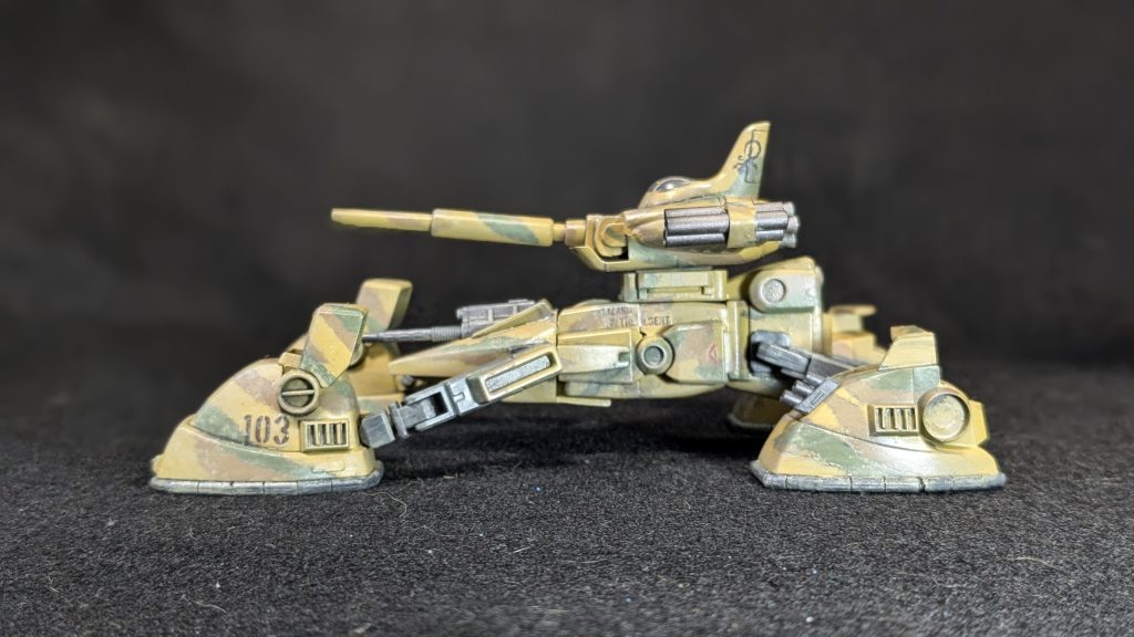 連邦軍が開発したモビルスーツGM。だがその機体は通常のGMと違い砂漠用の塗装がされていた。 各部のデザインも資料とは違う。 「こいつらが砂漠用に強化されたGMか?」 3機のGMの攻撃をジグザグに後退しながら、迎撃する。 初弾はシールドで捌かれたが、次弾は別のGMの足を撃ちぬいて擱座させた。 そして、差し出された頭部を撃ち抜いた。 ワンテンポ遅れて起きた爆発にあわせてスモークを発射して速やかに後退する。 小さな丘を越えてGMが見えなくなった。その小さな丘を飛び越えて2機のGMが姿を現した瞬間、その2機は蜂の巣になった。 「お疲れ」 「ありがとう。助かったよ」 その丘の影には同じトカゲ部隊のMSが待ち構えていたのだ。 「実戦テストは上々の様だな」 「悪くないね、重鈍なMS相手なら十分闘えるよ」 戦車としては十二分な性能に満足して、砂塵の中に消えて行くのだった。