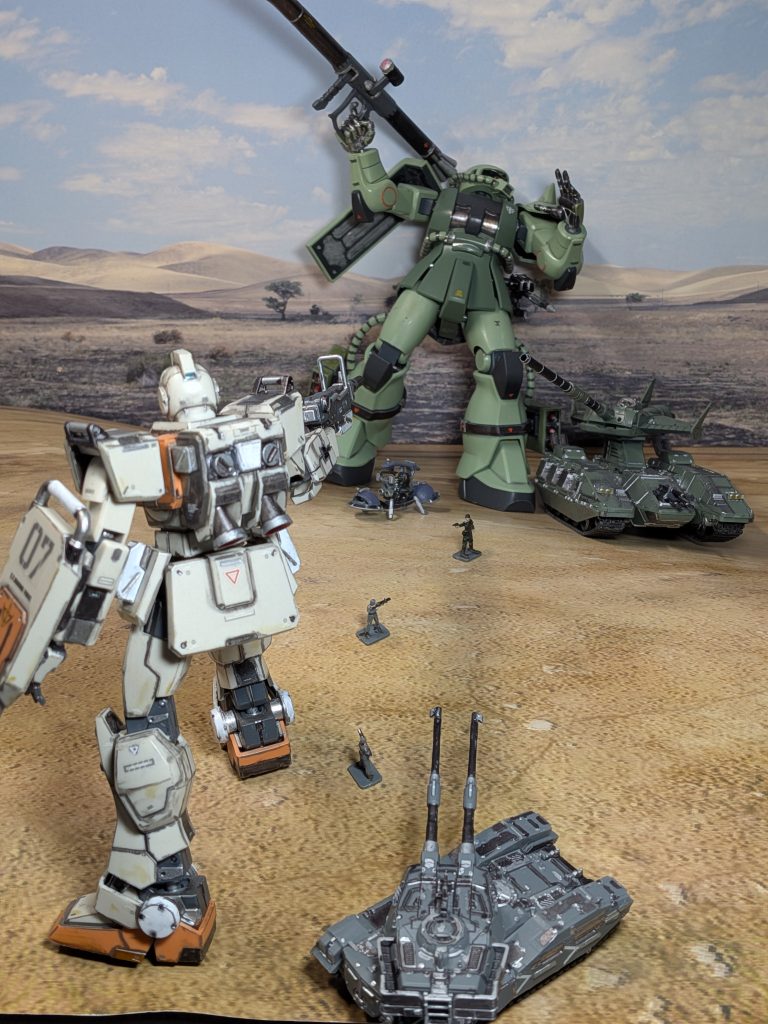 アピールショット１枚目を上から撮った図ここに爆発やミサイルのエフェクトを貼る加工をしましたちなみに、シートの下に物を入れて丘になるようにしてます