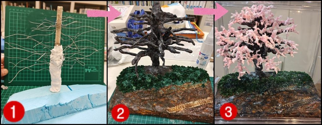 ジオラマについて１．Seriaのポリスチレンフォームに割り箸を立てて、針金を巻き付け紙粘土を巻いていきます。２．地面にも紙粘土、草はダイソーのグリーンモスという謎の草。ジオラマ界隈には芝生パウダーというものがあるらしく、重曹をグリーンの塗料の中に入れて作ろうとしたら、半分ぐらいしか塗料が乗らず、塗料が少なかったのかなぁ～？と使用せず。直接、グリーンモスの上から色味を足していきました。地面と木は、アクリル絵の具のローアンバーって色で塗っていき、木は黒とか白を足したりなんだり。地面は凹凸を意識して濃いとこ薄いとこ、黒を乗せたりとか。ガンタンクのキャタピラの跡を、押し付けたら塗装が剥げて紙粘土が見えてきちゃいました。木の枝が少なくて、このあとめちゃくちゃ増やしましたが、写真はありませんでした。３．ＡＩの指示のもと、桜の花を作成。メラミンスポンジを細かくちぎって、白で塗装（これ必要だったのかな？）→乾いた後、ピンク・薄ピンクに塗る。白も少し残しておく。枝の先の方に木工用ボンドで一つ一つ乗せていく。気が遠くなるような作業だった…。カメラに映しながら、足りない部分に花を追加しては確認。の繰り返し。地面と草も色を重ねては、離れてみたりカメラを通して見てみたり。
