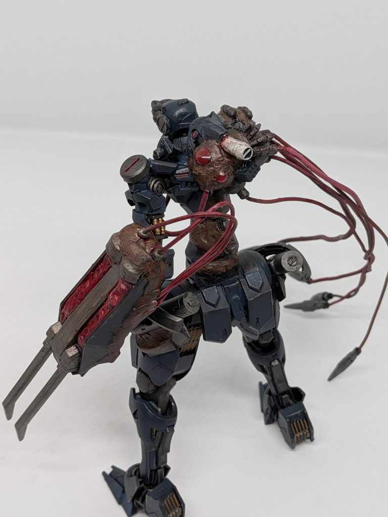 インペルフェルトセラフィムがMB化したなれのはてMBを使役することが可能であり、戦闘能力は従来のMBより高く左腕にジャンクパーツを取り込み形成されたクローユニットを扱う、背中から生えている5本の触手を使う、5本の触手を合わせ巨大な触手を作り引っかきや叩きつけなど多彩な攻撃を仕掛けてくる右腕部が眼球に変異しているさらに寄生ウィルスを注入しMSをMB化させる。（パイロットは取り込まれコアに変異する）