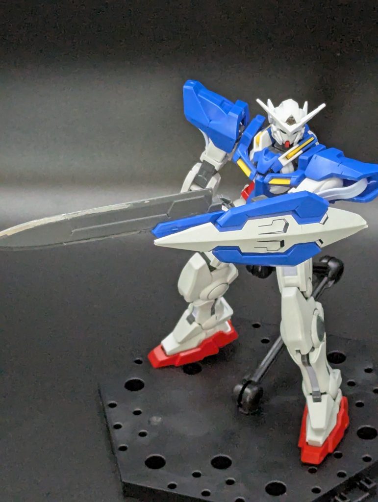 一番頭を悩ませたのはGNソードライフル形態にもなるエクシアのメイン武器で、プラモでもそのギミックは再現されていたのですが……まぁポロポロポロポロと、パーツが落ちること落ちること可変ギミックどころか普通に持たせるのも難しかった……ので、ライフルのギミックはもう良いやと割り切ってシールドにピンバイスで穴を開けてソードを直付け。ソードシールドに個人的な趣向としては、ギミックよりもポロリ防止を優先したい弄ってたりポーズを作ってるときにポロッとパーツが落ちると萎えてしまうなので外れやすいパーツは場所に応じてタミヤセメントで固定したり、切断したり、割り切って外してしまったりします見てくれよりも弄ってるときの楽しさ、快適さを重視