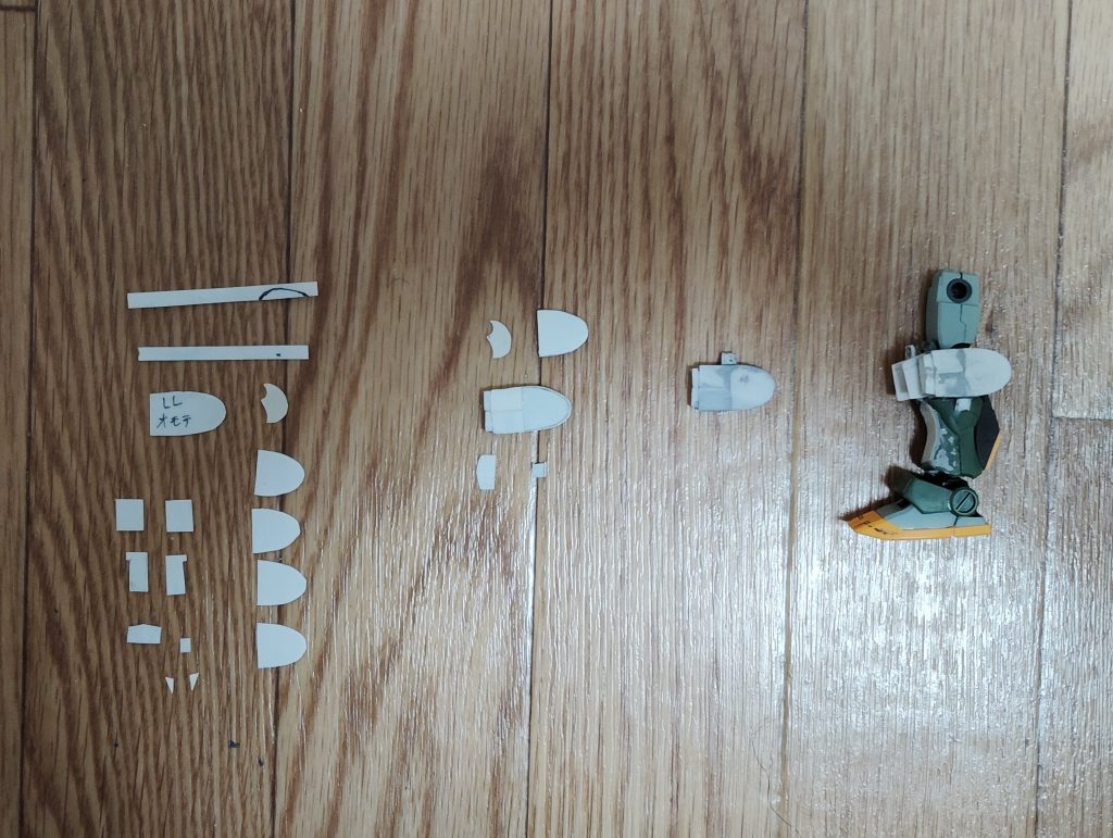 　ホバーユニットです。　この部分が一番苦労しました・・・。　まずは必要なパーツを0,5mmのプラ板から切り出し（一番左）、細長いプラ板を折り曲げて外装を作りつつ、半分に切った楕円型のプラ板に貼り付けて形を作っていきます（中央左側）。　各パーツを貼り付けてパテで表面を処理したらホバーユニットの完成です（中央右側）。　最後にホバーユニットをスネ側面に取り付け、ようやく形になりました。　苦労したぶん満足のいくデキにはなりましたが、しばらくこの加工はやりたくありませんね・・・。